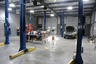 Independent garage workshop interior with vehicle lifts — grow your garage business online